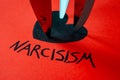 Word Narcisism, written in black on red paper Royalty Free Stock Photo