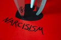 Word Narcisism, written in black on red paper Royalty Free Stock Photo