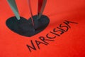 Word Narcisism, written in black on red paper Royalty Free Stock Photo