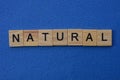 Word natural made from brown wooden letters lies