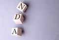 Word NDA on wooden block on the grey background Royalty Free Stock Photo
