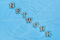The word network with wooden letters in the form of an abstract spider web Royalty Free Stock Photo