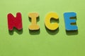 The word NICE in wooden letters