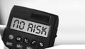 Word No risk on display of calculator on blurred ocean background. Finance concept Royalty Free Stock Photo