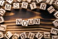 Word noun composed of wooden cubes with letters Royalty Free Stock Photo