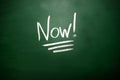 The word Now! on blackboard. A time management concept Royalty Free Stock Photo