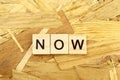 word NOW made of wooden blocks Royalty Free Stock Photo