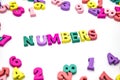 Word `numbers` is laid out of wooden multicolored letters