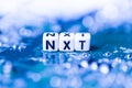 Word NXT formed by alphabet blocks on mother cryptocurrency