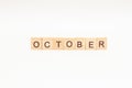 Word OCTOBER made of wooden blocks on white background. Month of year