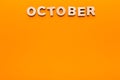 Word October on orange background Royalty Free Stock Photo