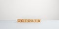Word October spelled on wooden cubes