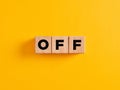 The word off on wooden cubes on yellow background Royalty Free Stock Photo