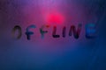 word offline handwrittern on foggy glass with cold neon blue back light Royalty Free Stock Photo
