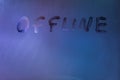 word offline handwrittern on foggy glass with cold neon blue back light Royalty Free Stock Photo