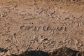 Word Okinawa on the sand of a beach