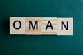 Word oman made of small gray wooden letters