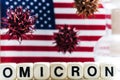 The word OMICRON is assembled from cubes and bacteria on the background of the USA flag. Concept of the new virus CAVID19 omicron