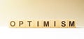 Word OPTIMISM made with wood building blocks Royalty Free Stock Photo