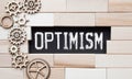 word Optimism on wooden block, business concept Royalty Free Stock Photo