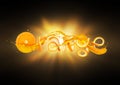 The word Orange made of peel with splashes of juice on the background of a flash of light in the dark