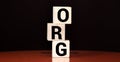 The word Org written on cube blocks on grey blue background with copy space available