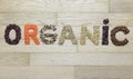 Word organic made of different seeds on a wooden background