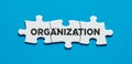 The word organization on connected jigsaw puzzle pieces. To organize in business