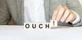 Word ouch made with wood building blocks