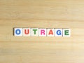 Word Outrage on wood background Royalty Free Stock Photo