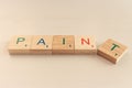 Word pain and paint in wooden cubes. Choice concept. Word paint in letters. Negative or positive. Alphabet in wooden blocks. Royalty Free Stock Photo