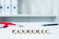 Word pandemic on wooden blocks in a doctor`s office Royalty Free Stock Photo