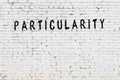 Word particularity painted on white brick wall Royalty Free Stock Photo