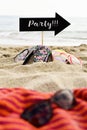 Word party in arrow-shaped signboard on the beach Royalty Free Stock Photo