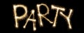 Word party written with sparkler letters Royalty Free Stock Photo