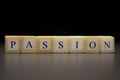 The word PASSION written on wooden cubes isolated on a black background