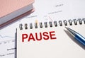 The word PAUSE on a paper notepad. Business break concept Royalty Free Stock Photo