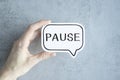 The word Pause written on a card in hand Royalty Free Stock Photo