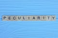 word peculiarity made from wooden gray letters Royalty Free Stock Photo