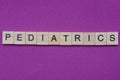 Word pediatrics from small gray wooden letters Royalty Free Stock Photo