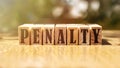 Word PENALTY made with building wooden blocks on table in sunlight Royalty Free Stock Photo