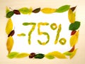 Word 75 percent made of autumn leaves inside of frame of autumn leaves on wood background. Seventy five percent. Sale template