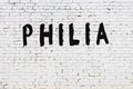Word philia painted on white brick wall Royalty Free Stock Photo