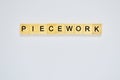 Word piecework. Top view of wooden blocks with letters on white surface Royalty Free Stock Photo