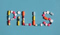 Word Pills Is Lined With Colored Pills And Tablets On A Blue Background Royalty Free Stock Photo