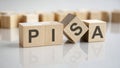 word Pisa on wooden cubes, gray background