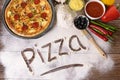 Pizza word written in flour, ingredients, making pizza