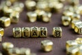 Word PLAN B made from small golden letters on the brown backgrou Royalty Free Stock Photo