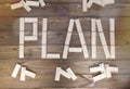 Word plan laid out of wooden blocks on a wooden background.