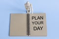 Word PLAN YOUR DAY on a blue background Royalty Free Stock Photo